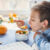 A young boy eating food from a bowl.