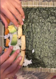 Plant-based sushi: nori, rice, tofu, avocado and mandarins.