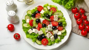 salad with lettuce, olives, tomatoes, cucumbers, and feta cheese.