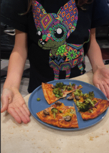 Plant-based pizza with broccoli and mushrooms.