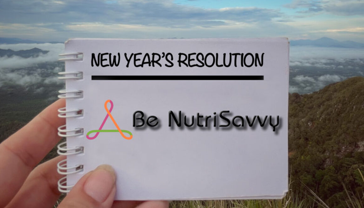 A person holding up a note with the words new year 's resolution written on it.