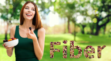 A woman holding a pen in her hand and the word fiber spelled out with nuts.