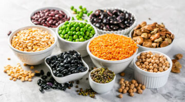 A table filled with bowls of different types of beans.