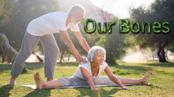 A man helping an older woman stretch on the grass.