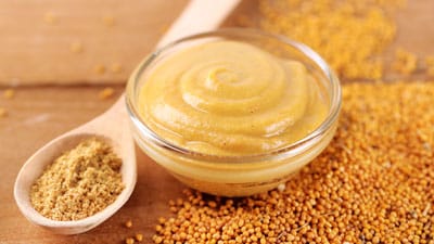 Be NutriSavvy A bowl of mustard next to some other food.